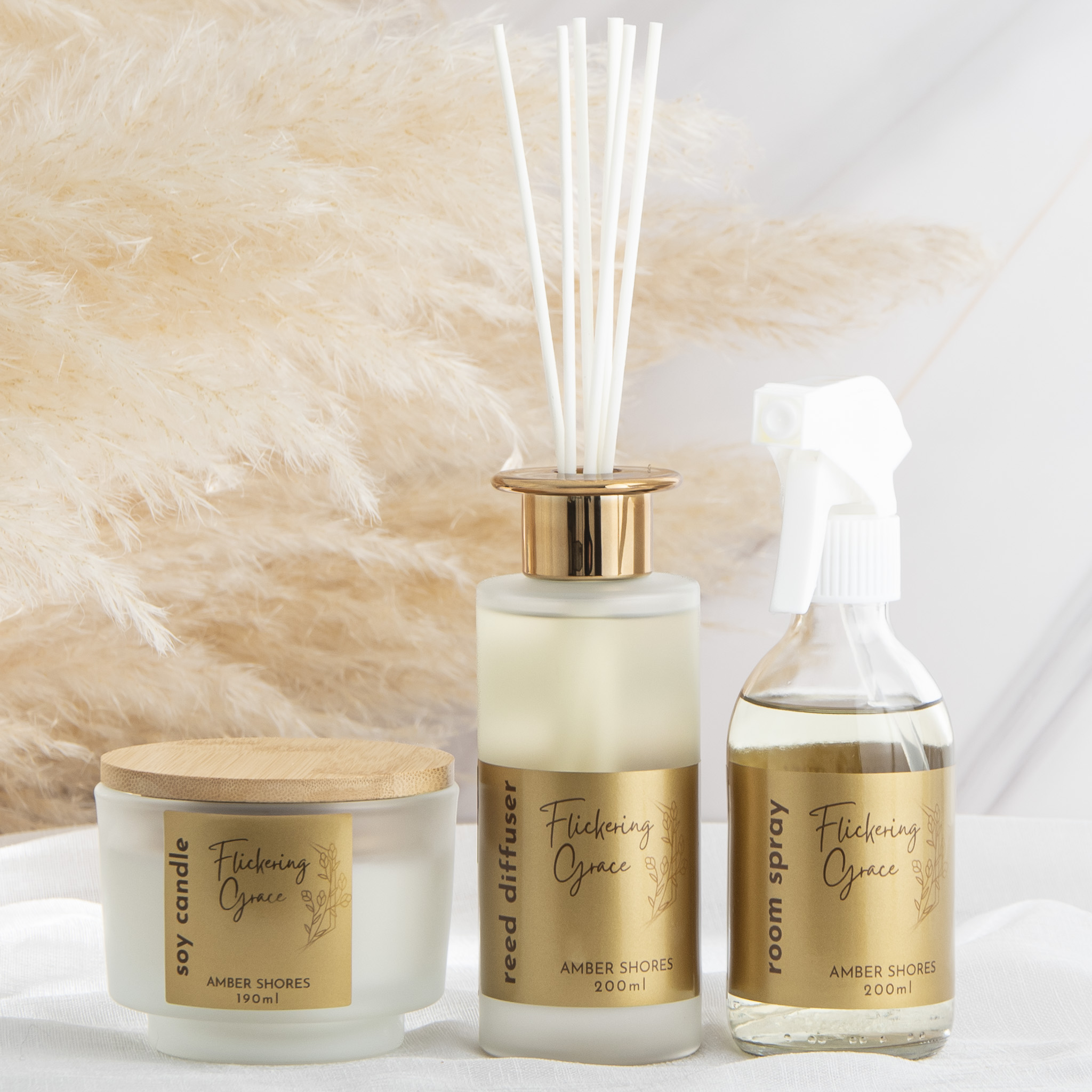 Amber Shores luxury gift box with soy candle, reed diffuser, and room & linen spray in coastal fragrance.
